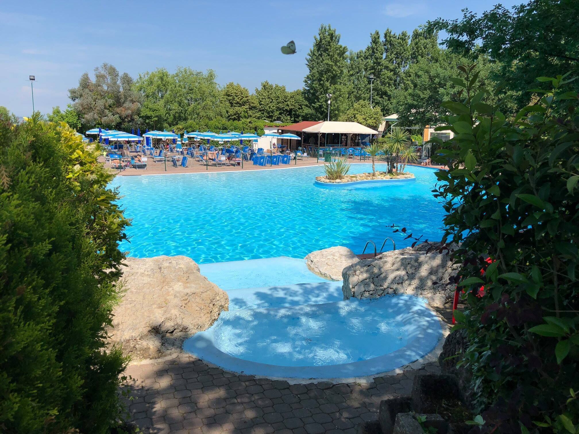 seasonal outdoor pool, open 9 am to 7 pm, pool umbrellas, pool loungers