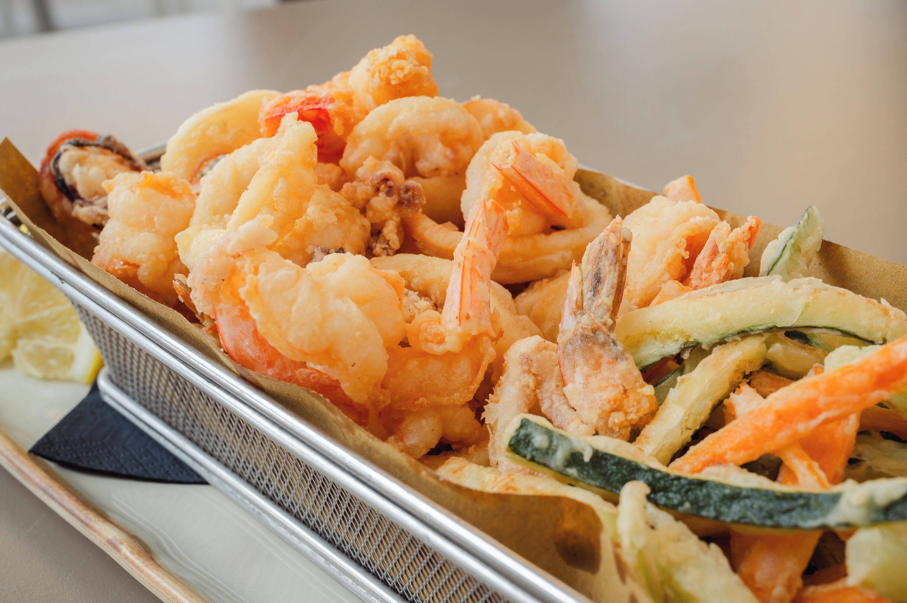 A tray of fried shrimp and vegetables.