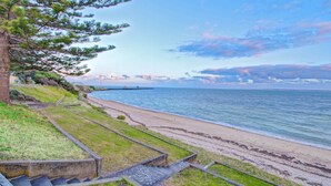 A coastal pathway leading to a beach with a pier in the distance. - Ozone Hotel Kangaroo Island (Kingscote)