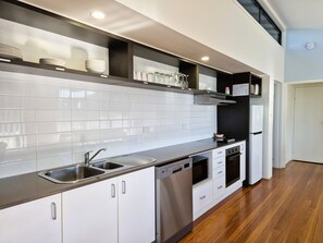 Townhome | Private kitchen | Full-size fridge, microwave, dishwasher, toaster