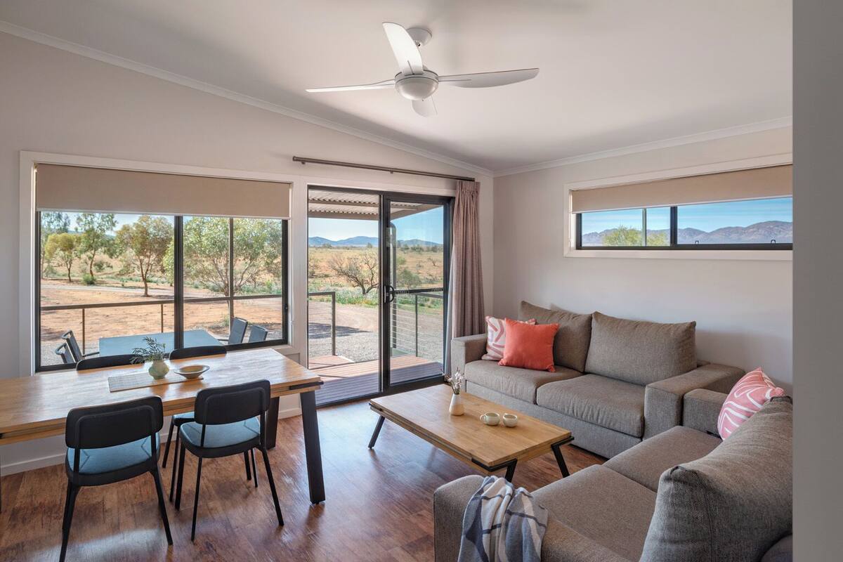 A spacious living area with a large window offering a view of the desert landscape.