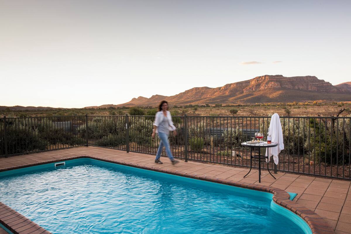 A swimming pool with a view of mountains in the background.