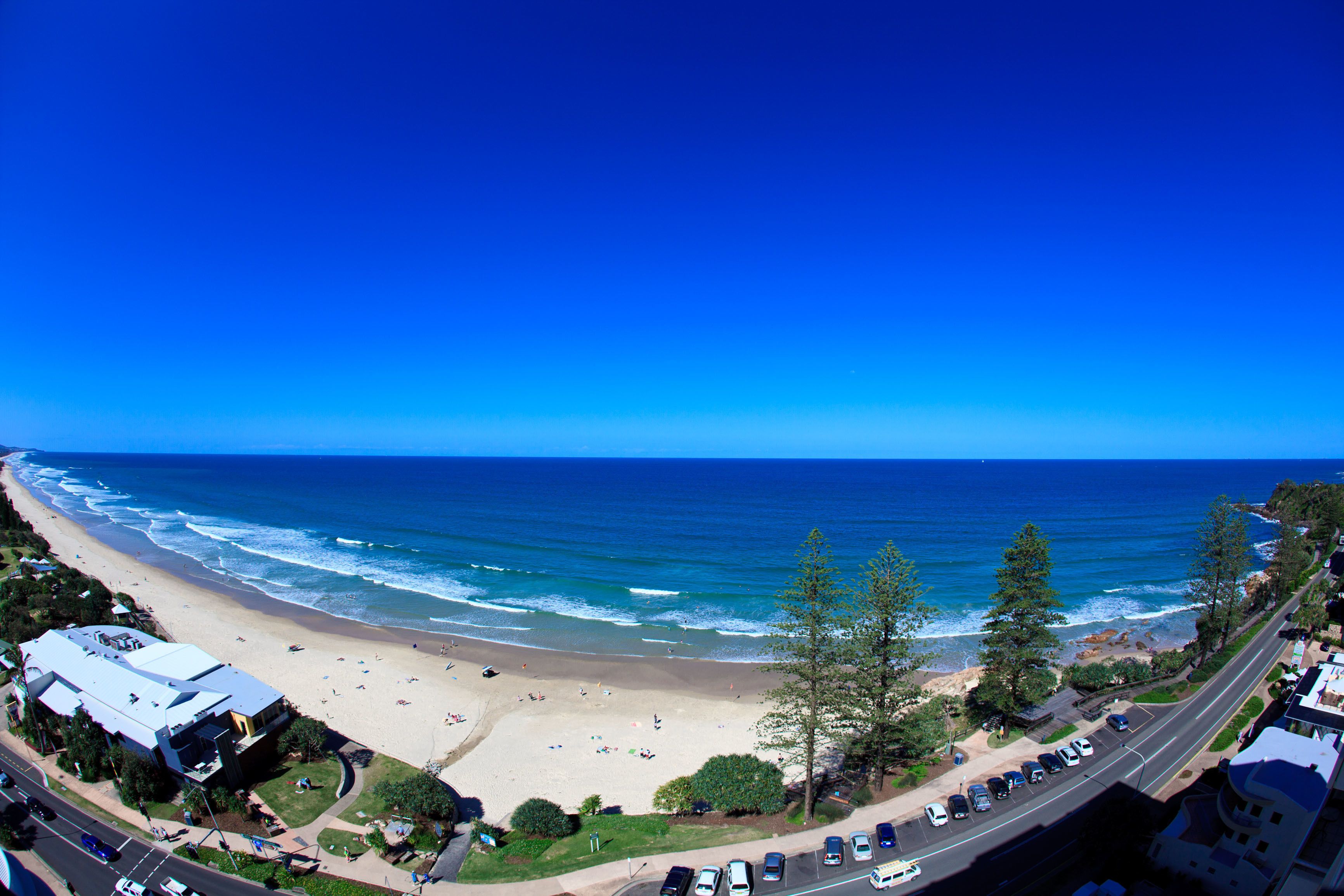 A coastal road with a beach and ocean view.