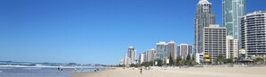 A beach with high-rise buildings in the background.
