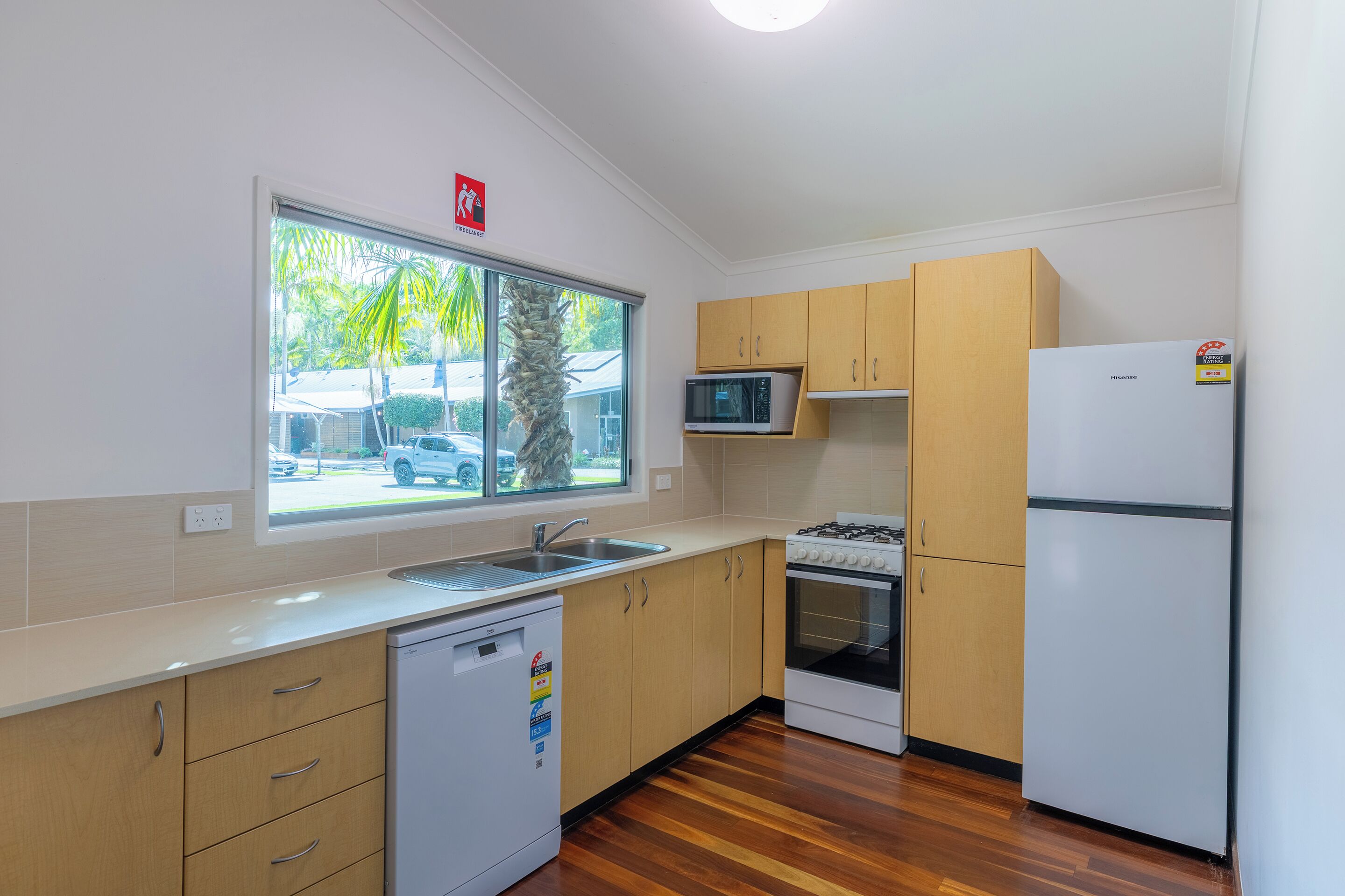 A kitchen with a dishwasher, microwave, stove, and refrigerator.
