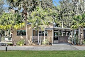 Sit on the covered porch and enjoy the lush surroundings.