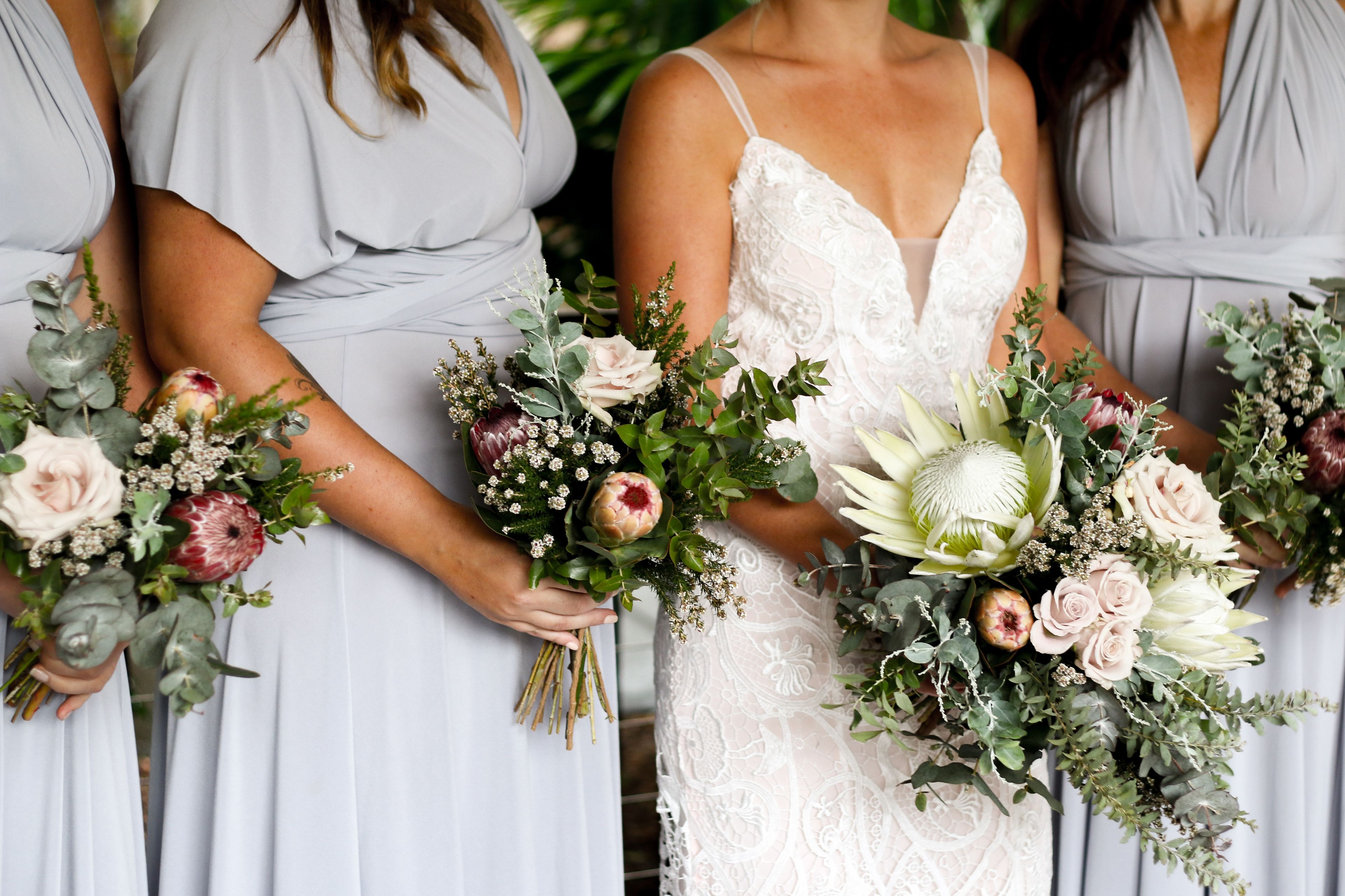 A wedding scene with bridesmaids holding bouquets.