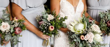 A wedding scene with bridesmaids holding bouquets.
