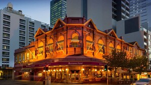 A historic building with a European Hotel and restaurant signage, surrounded by modern high-rise buildings. - European Hotel (Perth)