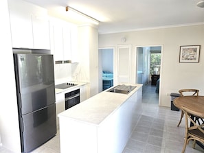 First Floor Apartment | Private kitchen | Full-size fridge, microwave, oven, stovetop - At The Mango Tree (Port Douglas)