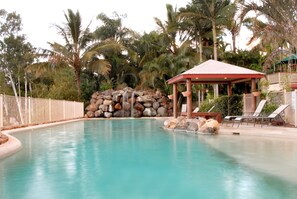 Outdoor pool, pool loungers - at Boathaven Bay Holiday Apartments (Airlie Beach)