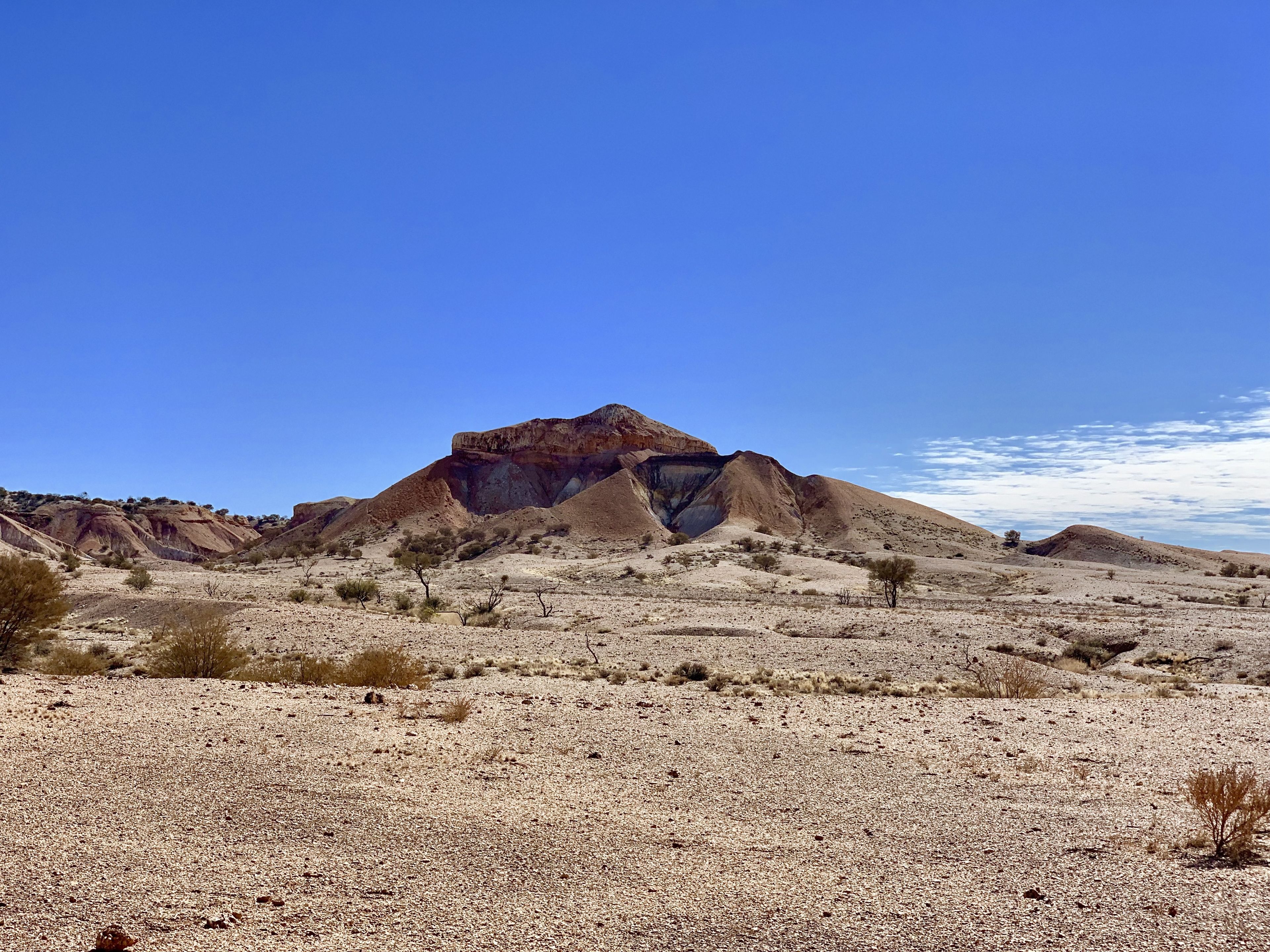 A desert landscape with a prominent rock formation.