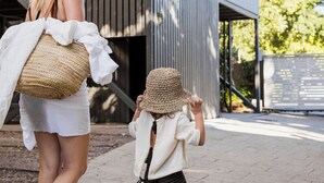 A woman and a child walking on a paved path. - The Hastings Beach Houses (Noosa Heads)