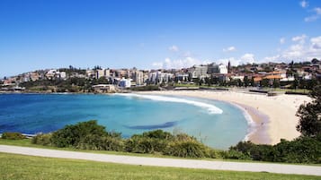 Beach nearby, white sand, beach towels