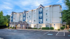 A multi-story hotel with a parking lot in front. - Microtel Inn & Suites by Wyndham Anderson/Clemson (Anderson)
