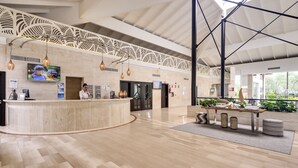 A spacious lobby with a reception desk, modern lighting, and a decorative ceiling. - Playa Garden Selection Hotel & Spa (Muro)
