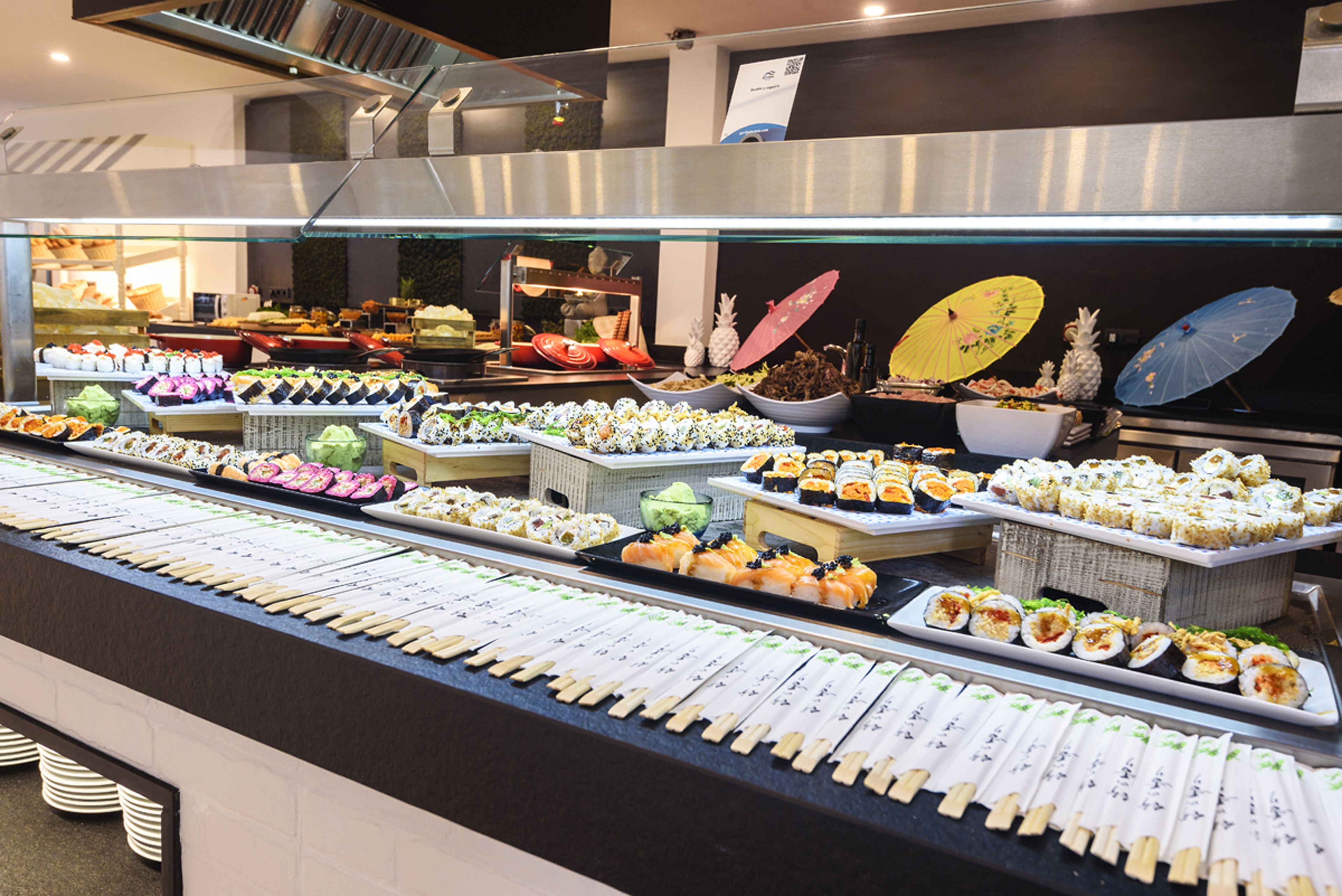 A buffet with various food items and a sushi bar.