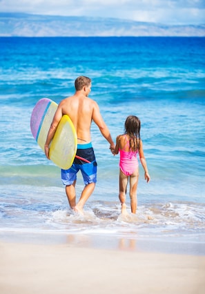 On the beach, surfing