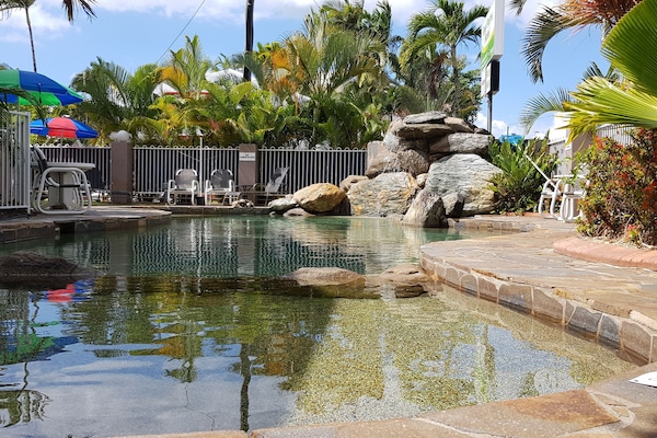 Alberca al aire libre y camastros