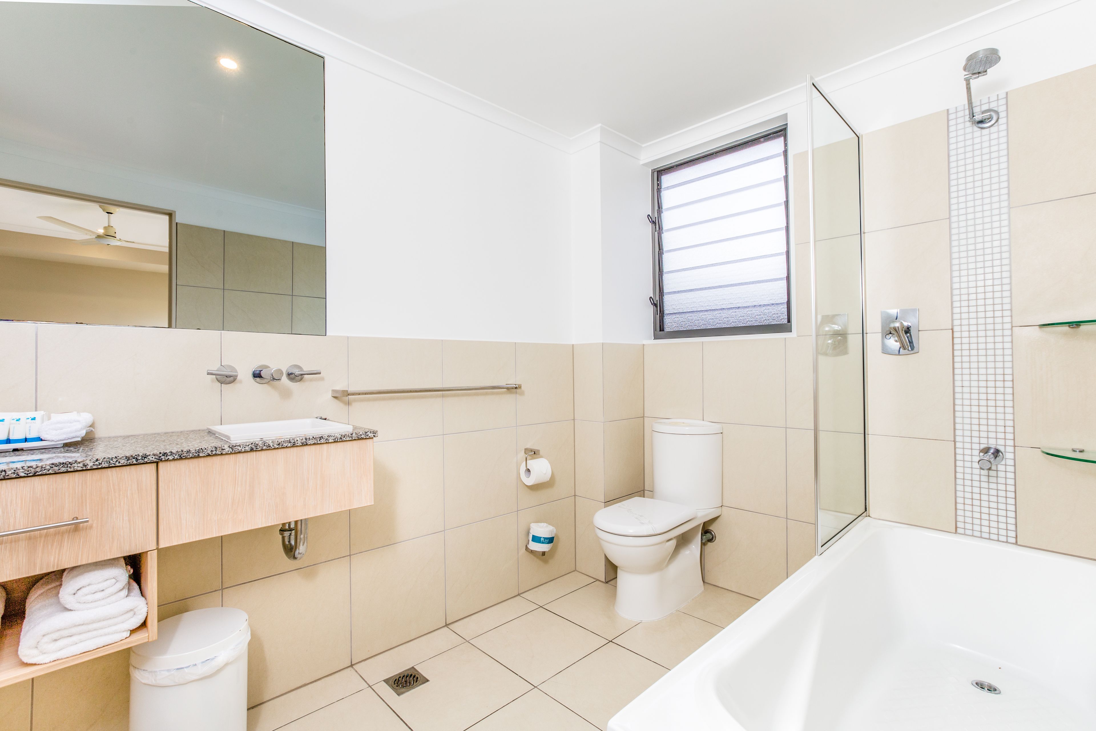 A modern bathroom with a bathtub, toilet, and sink.