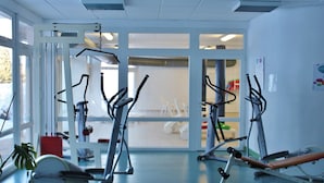A gym with various exercise equipment, large windows, and a view of the outside. - VVF Jura Les Rousses, Prémanon (Premanon)