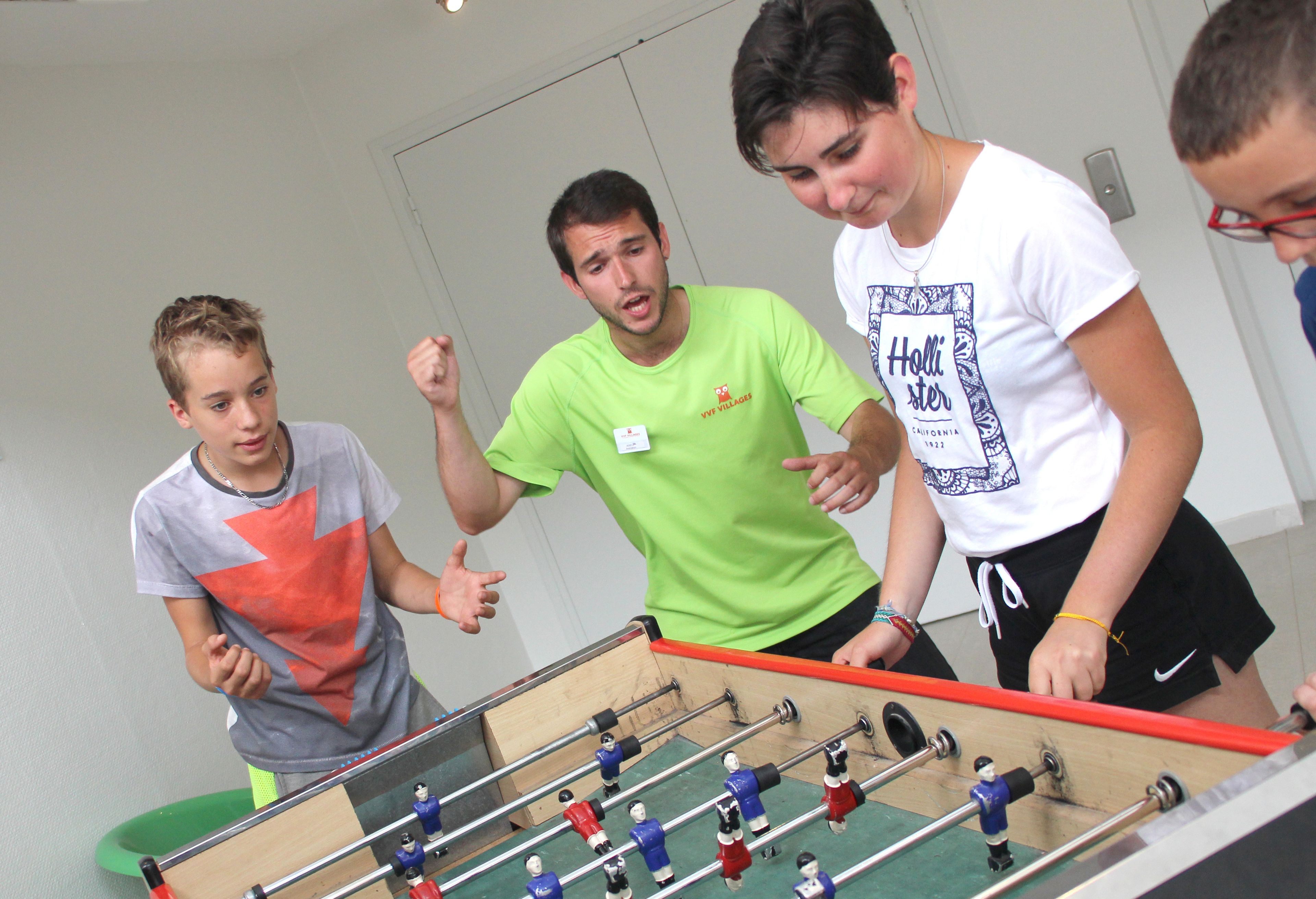 A group of people playing foosball.