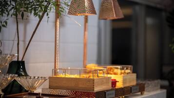 A display of decorative items including a lamp, a glass bowl, and a wooden box with a nameplate.