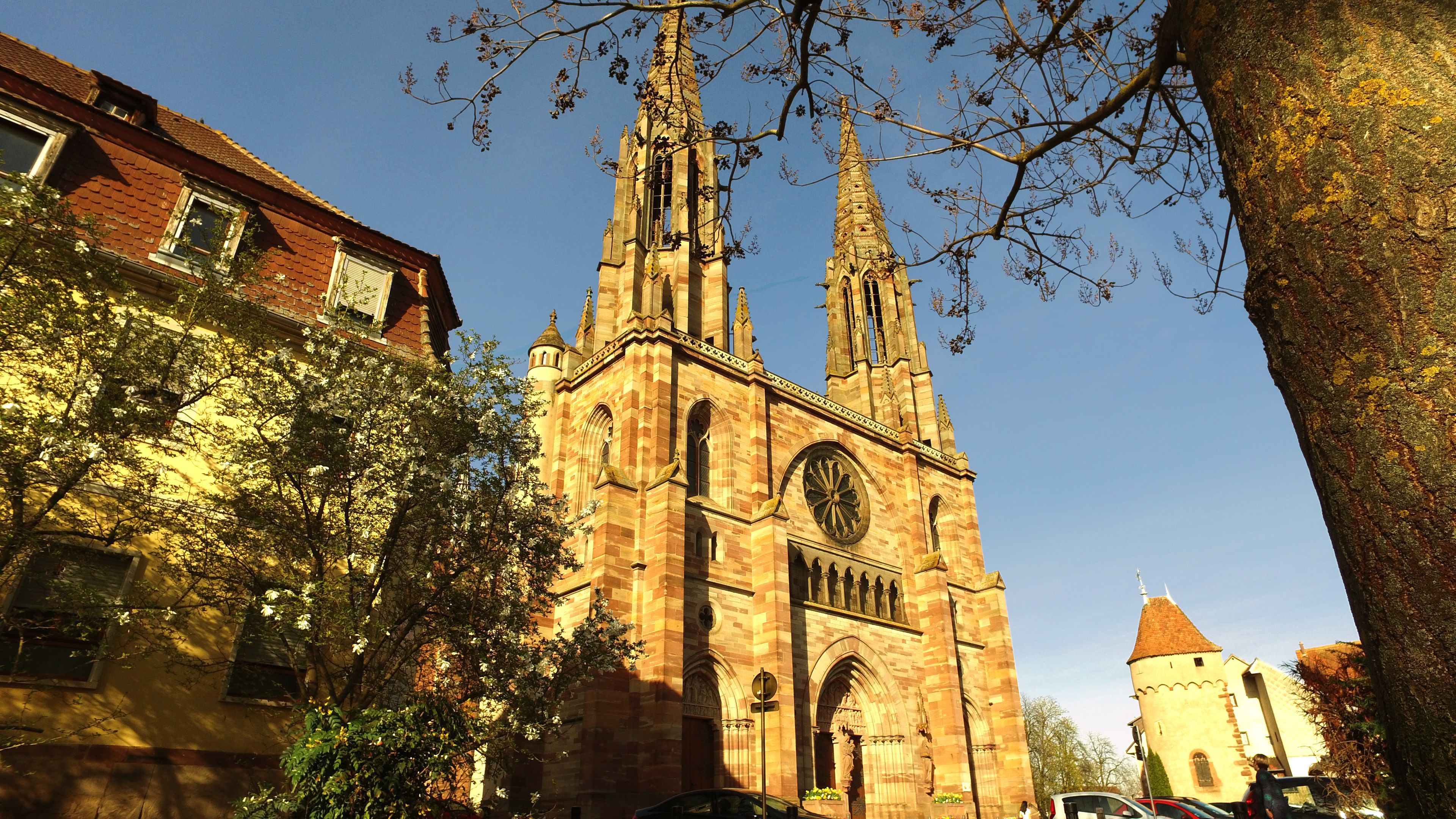 A historic church with twin spires and a large circular window.