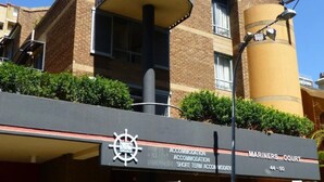 A building with a sign for "Mariners Court" and "Accommodation."