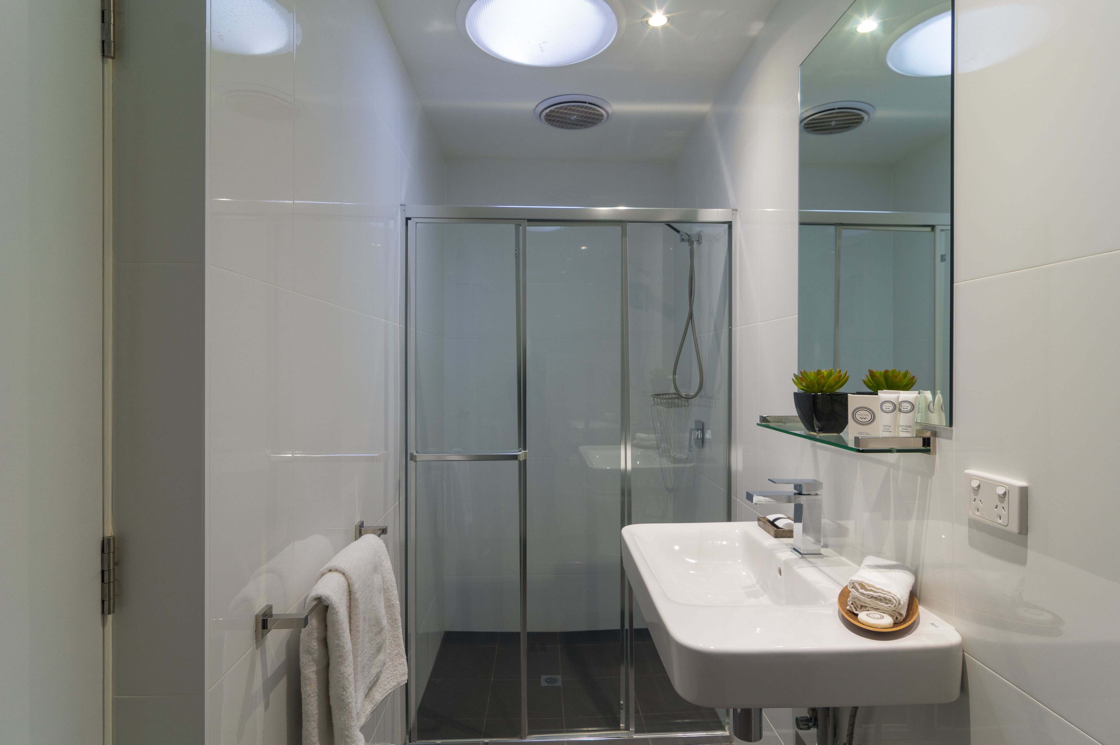 Een douche, designer toiletartikelen, een haardroger, handdoeken