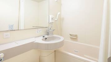 A bathroom with a white sink, mirror, and bathtub.