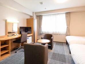 A hotel room with a bed, a desk with a computer, a chair, a small table, and a window with curtains. - Comfort Hotel Hikone (Hikone)