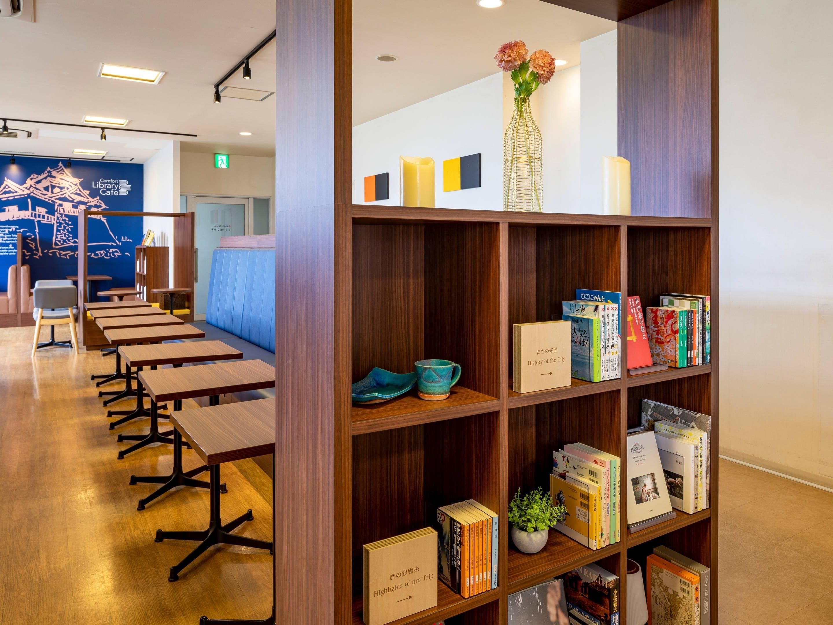 Un café en una biblioteca con mesas de madera y estanterías.