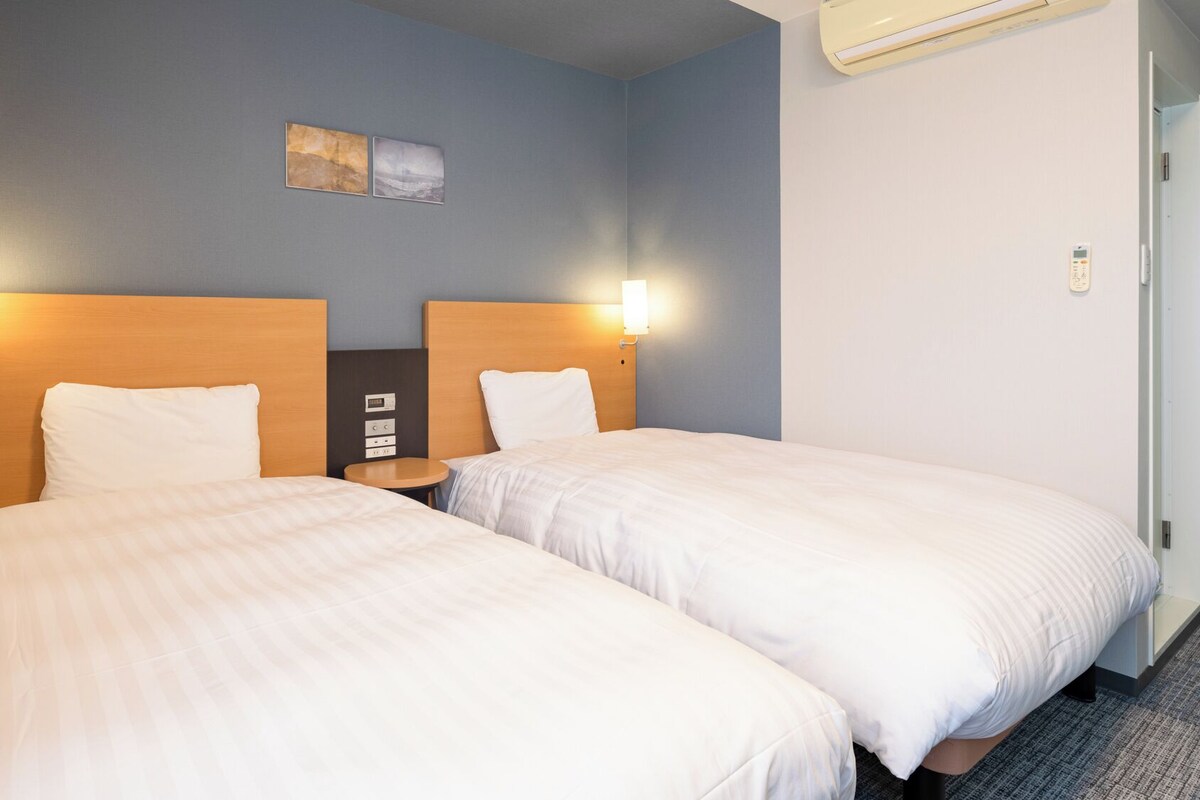 Premium bedding, desk, laptop workspace, blackout curtains