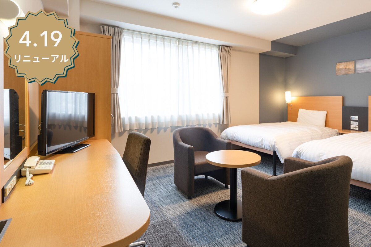 Premium bedding, desk, laptop workspace, blackout drapes
