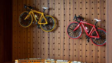 A wooden wall with two bicycles and a toy train.