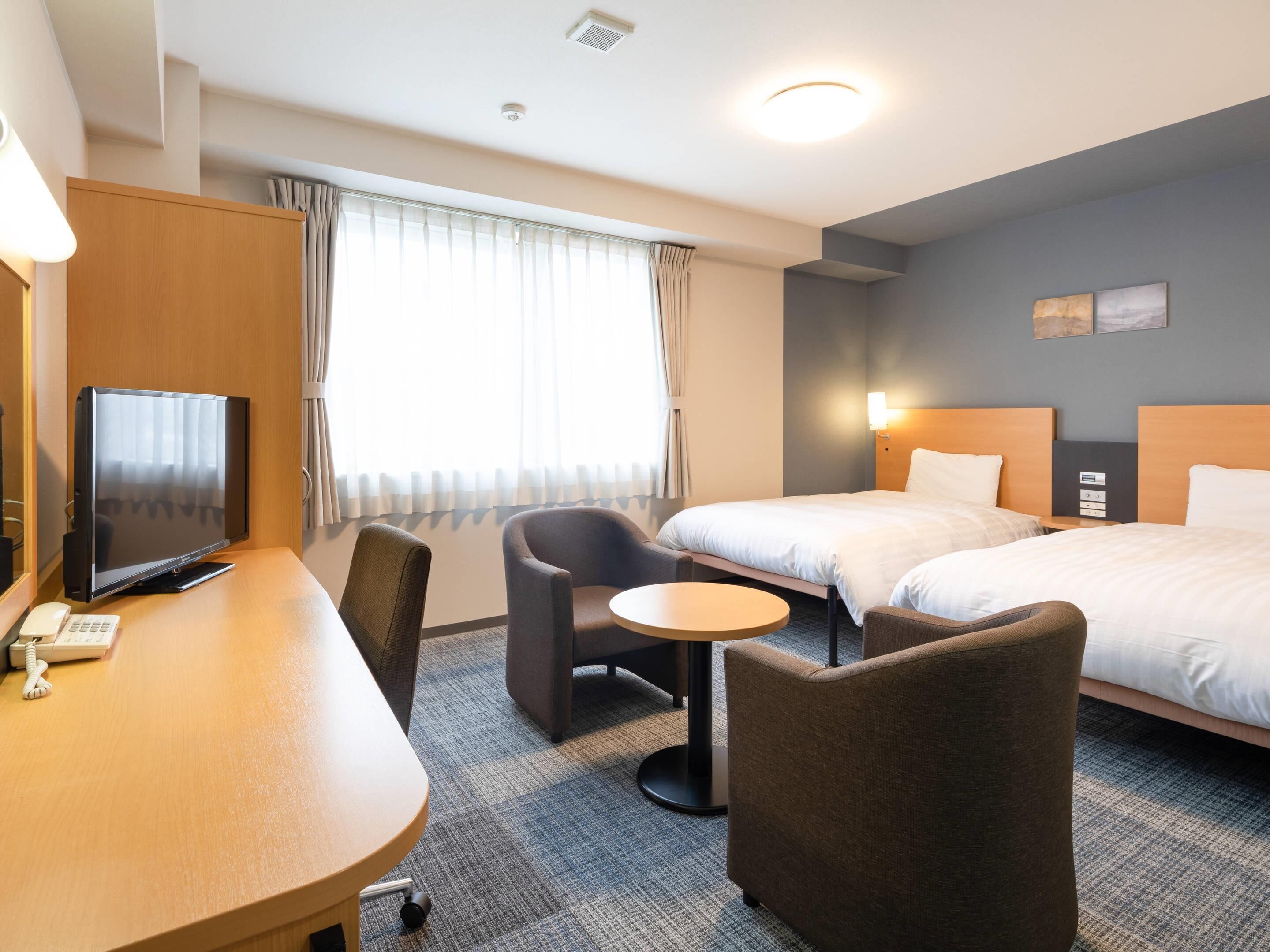 Premium bedding, desk, laptop workspace, blackout drapes