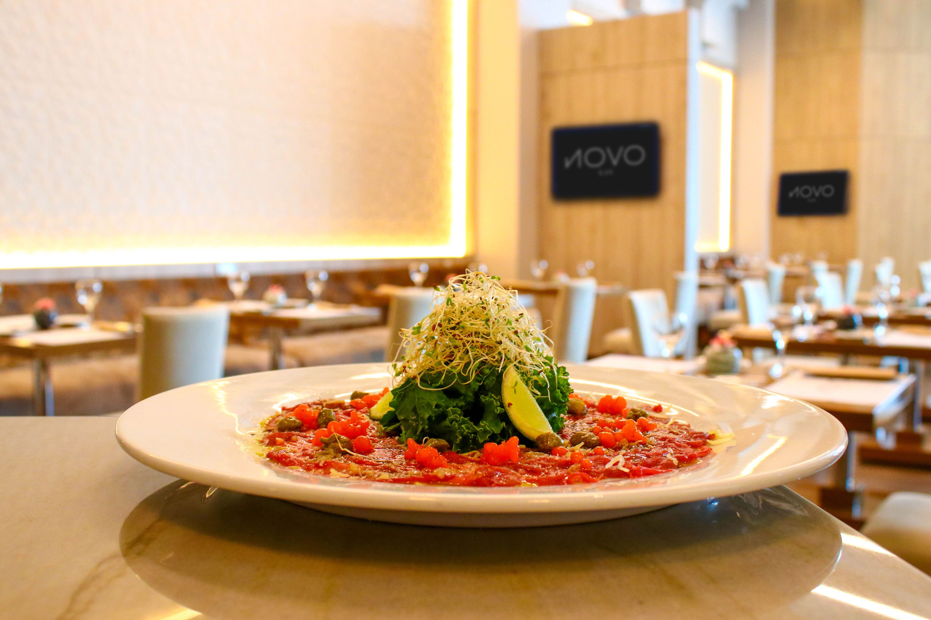 A restaurant setting with a plate of food on a table.
