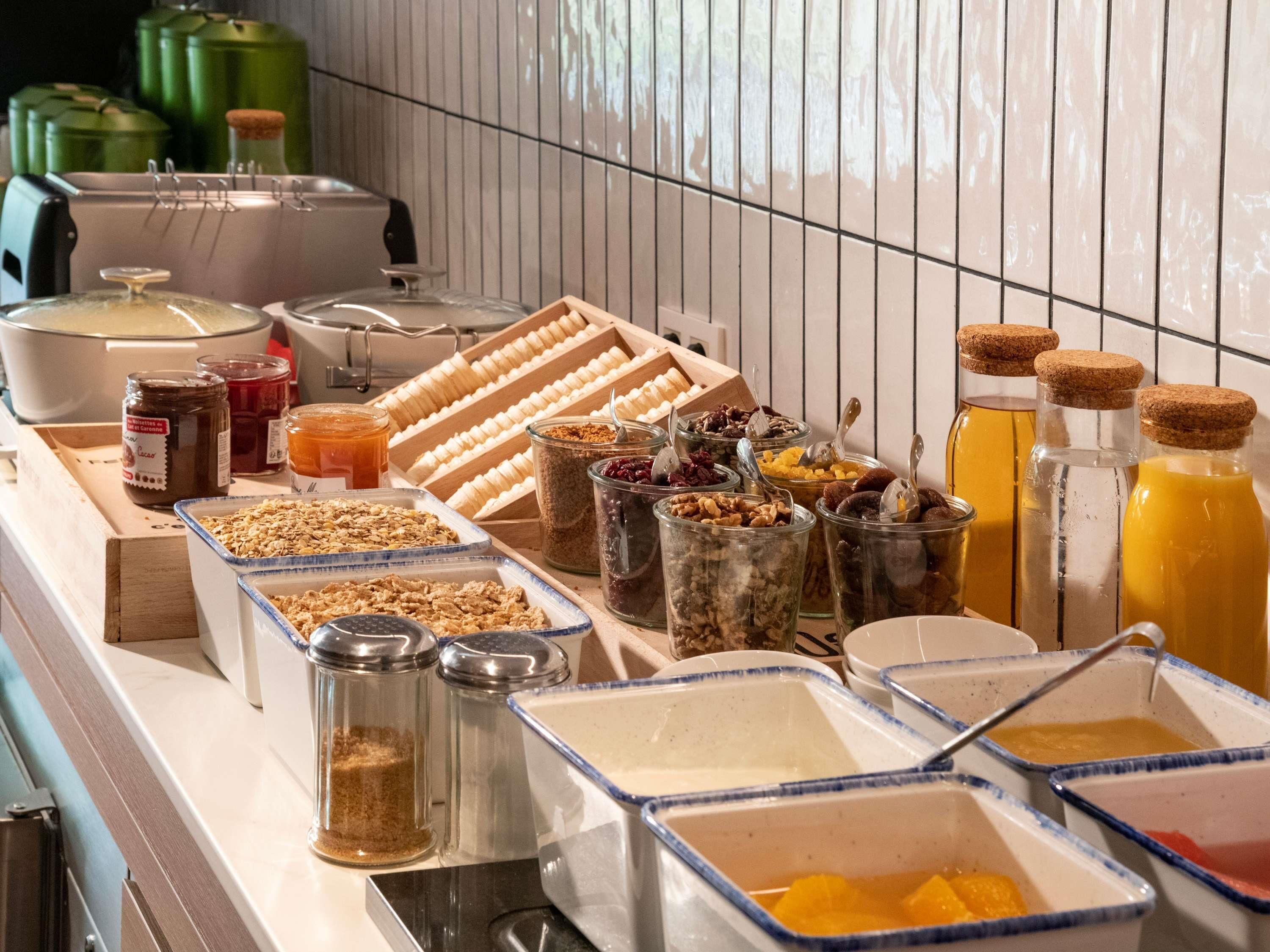A buffet with various food items and condiments.