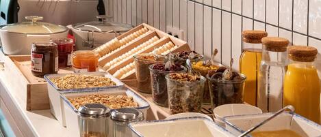 A buffet with various food items and condiments.