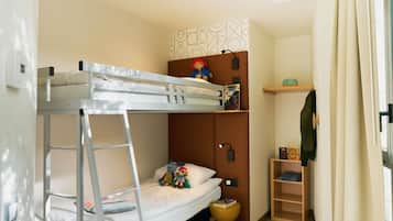 A bunk bed with a ladder, a small shelf with books, and a wooden ladder shelf.