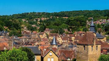 A historic town with traditional architecture, including stone buildings and a prominent church tower.