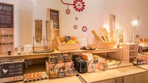 A bakery counter with various baked goods and ingredients. - ibis Sarlat (Sarlat-la-Canéda)