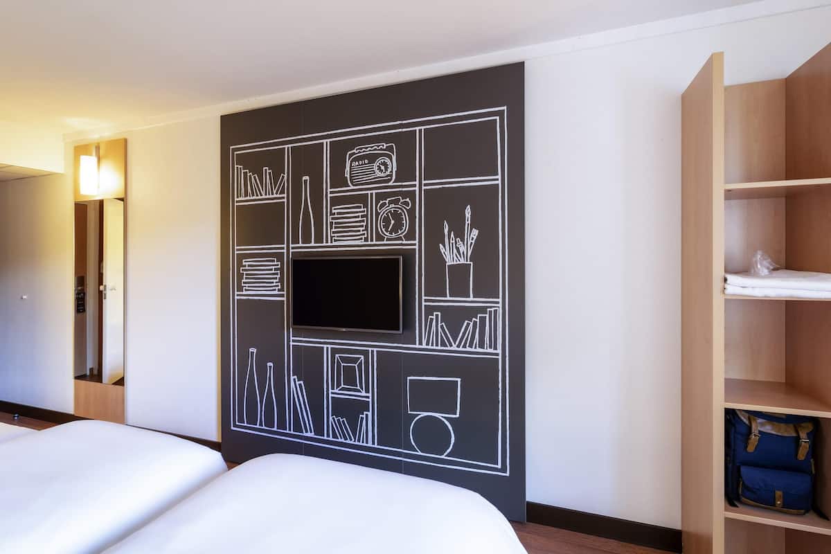 Premium bedding, desk, laptop workspace, blackout drapes