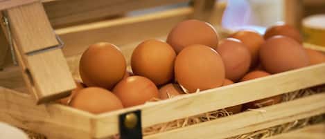 Una caja de madera llena de huevos marrones.