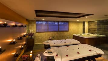 Relax in a serene spa room with a hot tub, two massage tables, and a reception area.