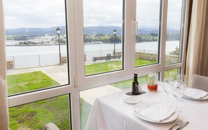 Enjoy a romantic dinner for two with a scenic view of the river and distant town from this dining area.