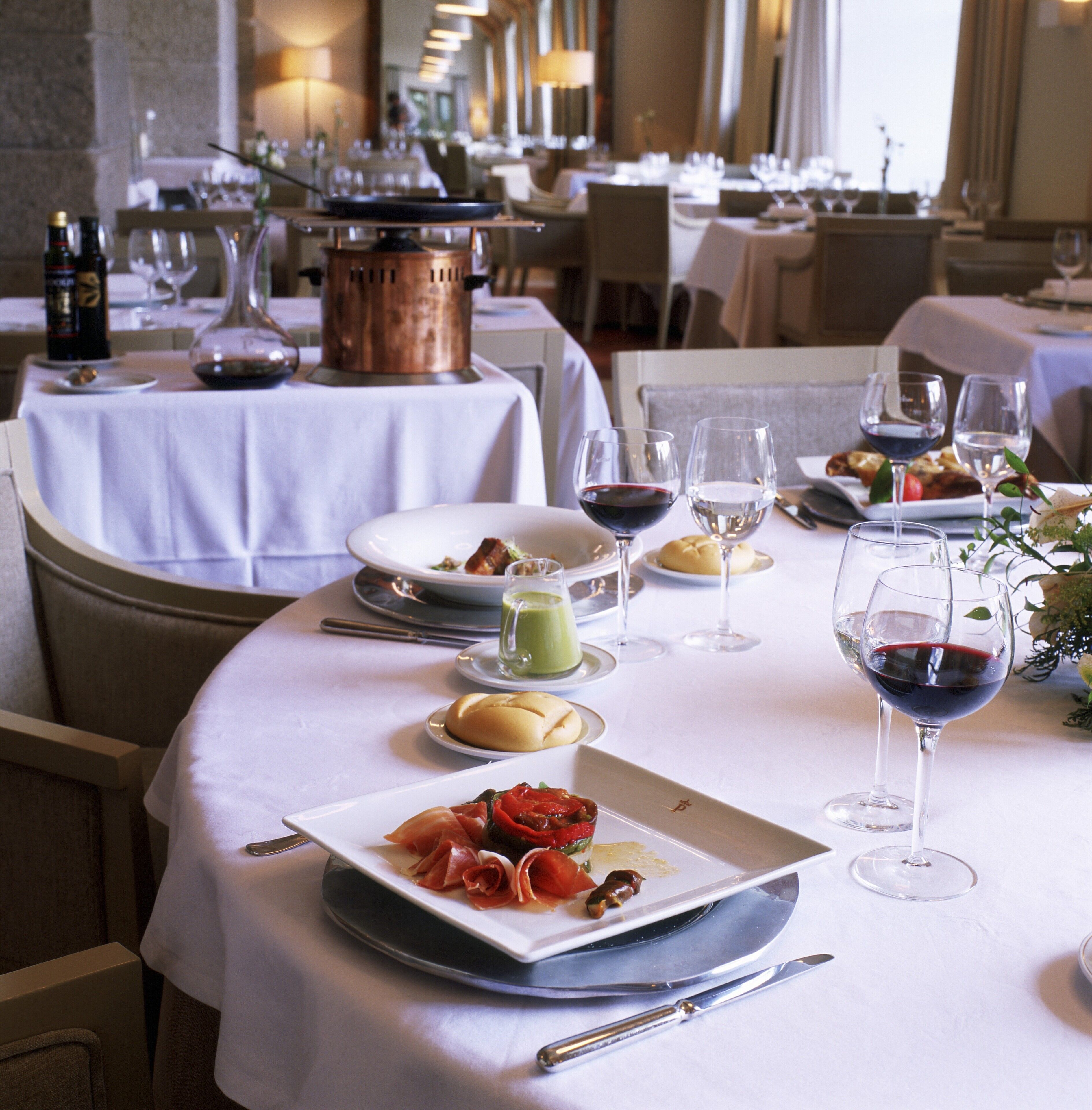 A dining table set with plates, glasses, and cutlery, indicating a restaurant setting.