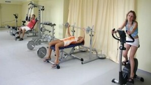 A gym with exercise equipment, including a bench press and an elliptical machine. - Marvel (Nessebar)