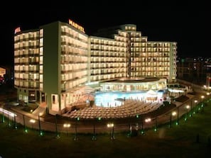 A multi-story hotel with a central atrium and a pool area. - Marvel (Nessebar)